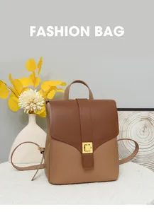 Close-up of color-block backpack leather texture with gold square metal buckle detail
