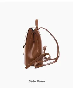 Side view of brown faux leather backpack with adjustable straps and gold metal buckles