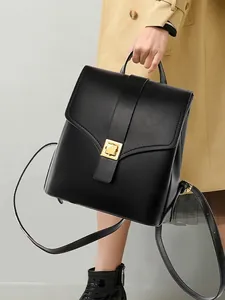 Minimalist black leather backpack for women with golden buckle and sleek carry handle