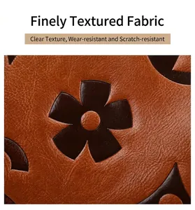 Close-up of brown litchi grain leather texture featuring dark floral patterns on a tote bag