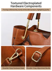 Detail of gold electroplated hardware and monogram pattern on brown leather tote
