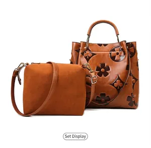 Detail of caramel bucket bag set with embossed patterns and matching crossbody pouch