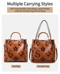 Close-up of the vintage brown tote showing embossed S-pattern and dual strap options