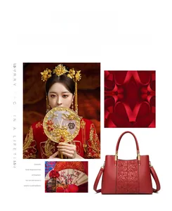 Detail of red Chinese wedding handbag with floral embossing and gold hardware accents