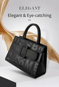 Detail of elegant black lychee pattern leather handbag with grey letter print and handles