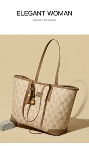 Detail view of large tote bag with brown M-pattern and cute bear pendant charm