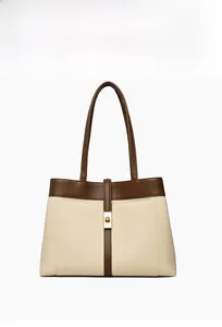 Detailed front view of a large canvas tote bag with brown leather trim and golden clasp