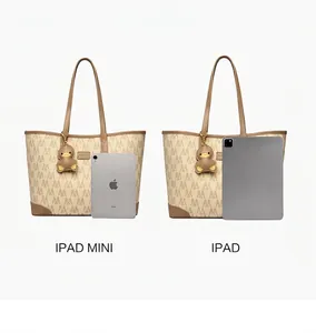 Detail view of large printed tote bag size comparison with iPad and cute duck pendant