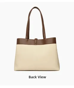 Back view of minimalist canvas tote bag with brown leather handles and buckle detail