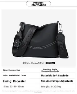 Close-up of black litchi grain leather crossbody bag with logo strap and size specs
