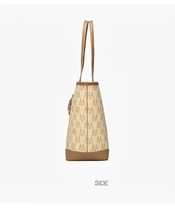 Side view of elegant tote bag with monogram print and dark brown leather straps
