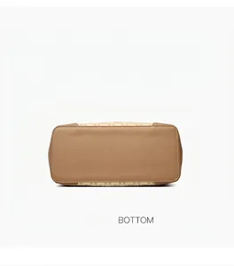 Detailed view of the brown leather bottom and premium stitching on the tote bag