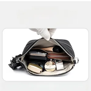 Internal view of large capacity leather crossbody bag showing smart storage for daily essentials