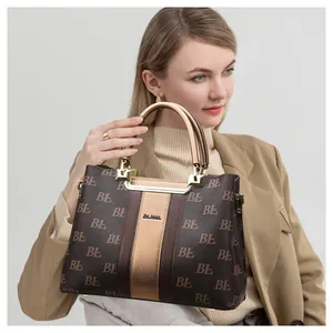 Classic monogram tote bag with gold vertical stripe and elegant leather top handles