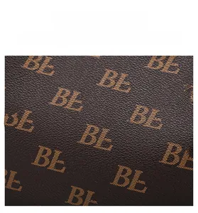 Macro view of dark brown textured leather featuring repeat BL monogram patterns
