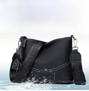 Close-up of waterproof grain leather texture and black and white knit shoulder strap