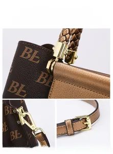 Close-up of golden hardware details and printed pattern on stylish women tote bag