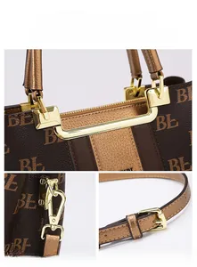 Detail of monogram tote bag with gold-plated hardware and adjustable shoulder strap