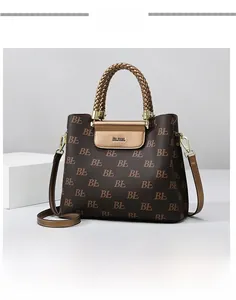 Detail of woven brown handle and logo buckle on vintage printed tote bag