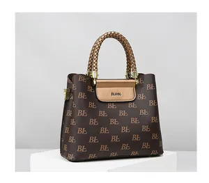 Detail of woven brown handle and golden metal flip cover on monogram tote bag