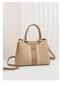 Detail of beige lychee grain leather tote bag with vertical stripes and gold hardware