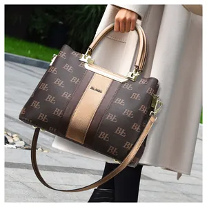 Detail of vintage tote bag featuring textured leather finish and elegant gold hardware