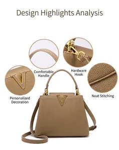 Detail of camel leather bucket bag showing golden V-shaped logo and stitch craftsmanship