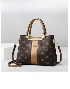 Detailed shot of monogram tote bag with champagne gold stripe and golden hardware