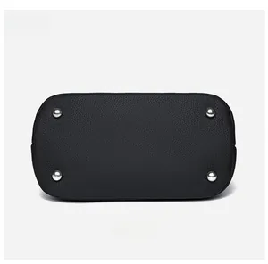 Detail of the black pebbled leather handbag base with four silver protective metal feet