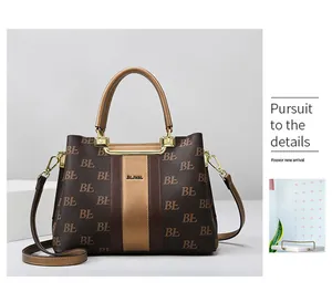 Detail of classic monogram tote bag featuring gold hardware and adjustable strap