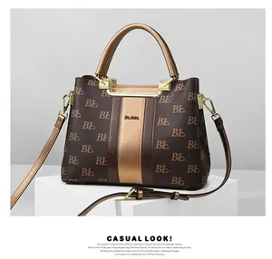 Detail of dark brown leather tote featuring gold BL monogram print and metallic logo