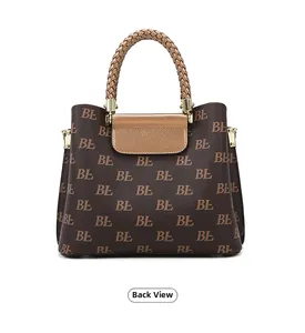 Rear view of a textured monogram tote bag with brown leather flap and woven handle