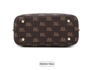 Detailed bottom view of brown tote bag with metal feet and floral pattern print