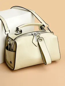 Modische beige Boston-Tasche aus weichem Leder mit geometrischen Mustern und Schultergurt