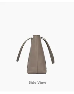 Side view of dark grey leather tote bag showing fine grain texture and trapezoid shape