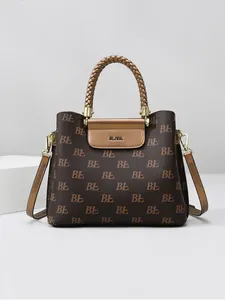 Classic monogram tote bag with woven handles and gold hardware in dark brown