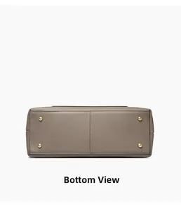 Bottom view of large tote bag in pebbled dark taupe leather with four gold metal feet