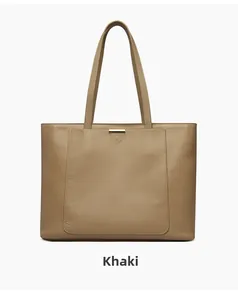 Detail of khaki leather tote bag with pebble grain texture and sleek gold metal bar accent