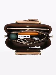 Brown leather tote bag interior view with multiple compartments for daily items