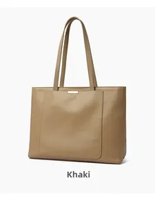 Detail shot of khaki leather tote bag showing high-quality pebble texture and stitching