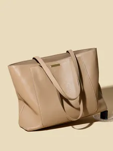 Minimalist beige pebble leather tote bag with gold metal trim and large capacity