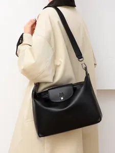 Detail showing high-quality black faux leather tote bag texture and soft structure
