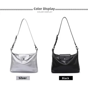 Detail view of silver metallic and black matte soft leather shoulder bags with M logo