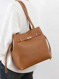 Classic brown leather bucket tote bag for women with gold buckle and shoulder strap