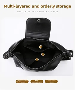 Detail view of the multi-compartment interior layout in a black leather tote bag