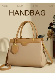 Detailed close-up of khaki pebbled leather handbag with gold hardware and brand lettering