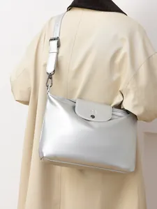 Silver metallic tote bag with wide shoulder strap and gunmetal buckle detail
