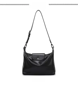 Detailed front view of soft black leather tote bag featuring a flap with M logo