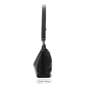 Side view of black faux leather tote bag with wide adjustable strap and silver buckles