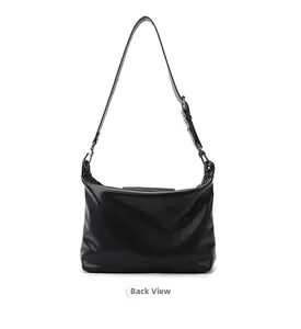 Detailed back view of a minimalist black soft leather tote bag with slim shoulder strap